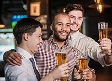 Photo of three friends drinking beer together