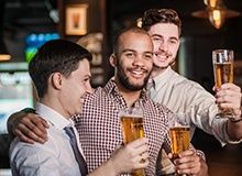 Photo of three friends drinking beer together